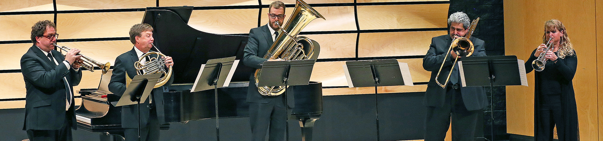 Brass players performing a fanfare at the Music Building grand opening celebration