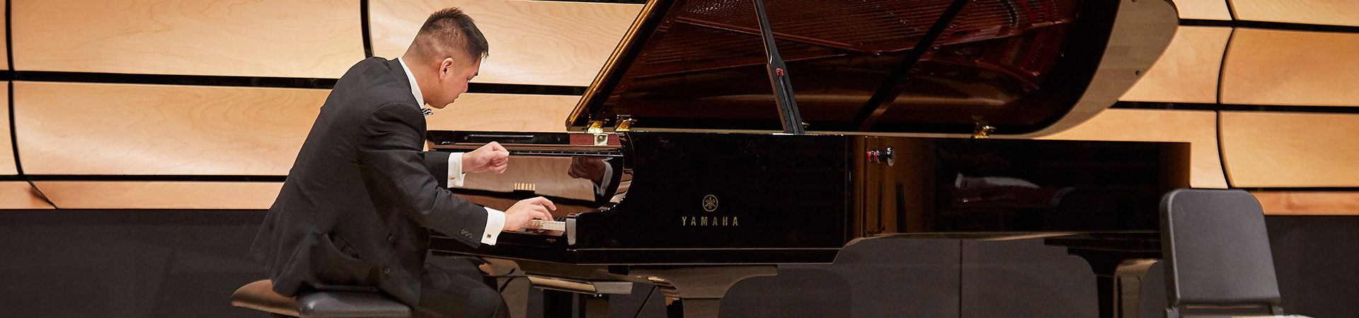 A student playing the piano in von Kuster Hall