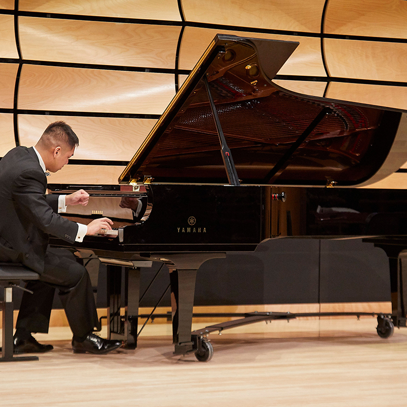 A student playing the piano in von Kuster Hall