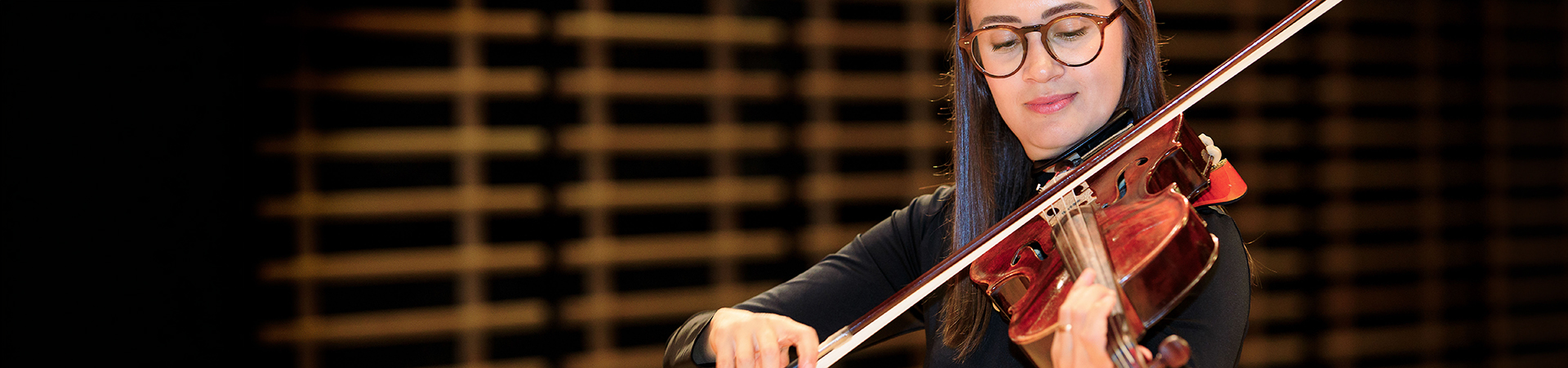 A viola player on stage performing