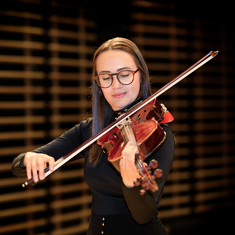 A viola player on stage performing