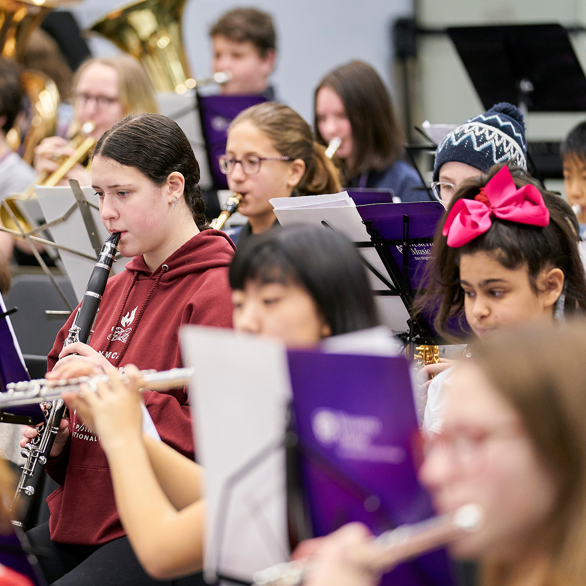 Students and children playing together in the Young Winds program