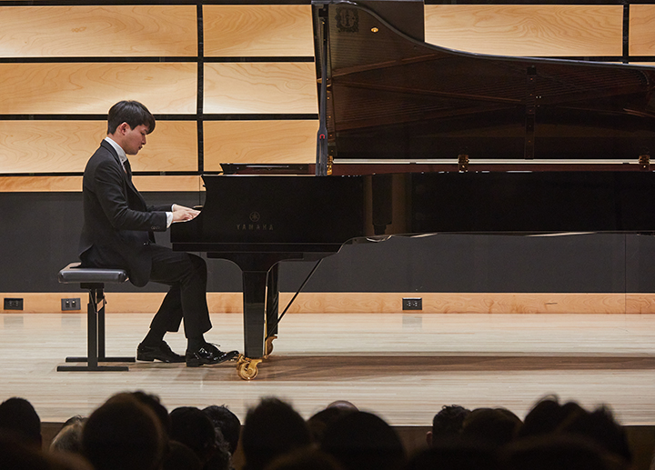 Guest artist performing on piano in von Kuster Hall