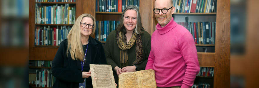 Western's Archives and Special Collections Library now houses two early examples of written medieval music. (L to R) Librarian Deborah Meert-Williston, music professor Kate Helsen and music library director Brian McMillan display the two parchment documents containing medieval nuemes. (Colleen MacDonald/Western News)