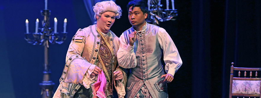 Two student opera singers performing in Baroque period costume