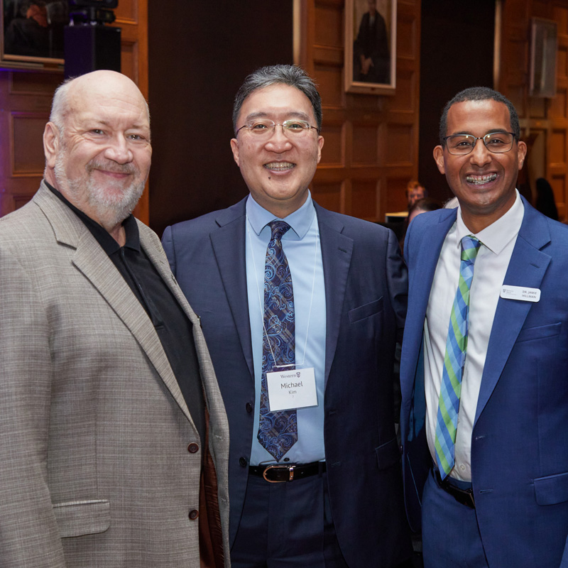 2024 Alumni Wall of Fame inductees Brian McIntosh (left) and Jamie Hillman (right) with Dean Michael Kim (centre) at the Alumni Award Celebration dinner during Homecoming 2024.