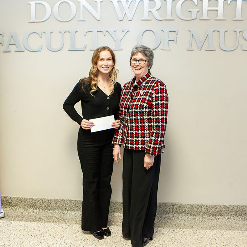 Music donor Mara Hitchins with a student award recipient
