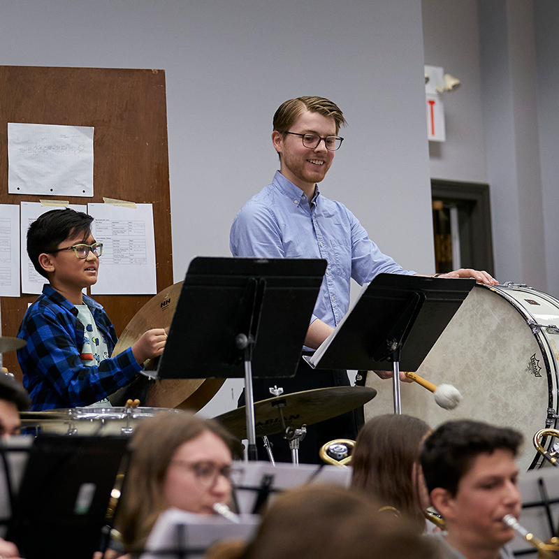 Music Education faculty and students working with children in a youth band program