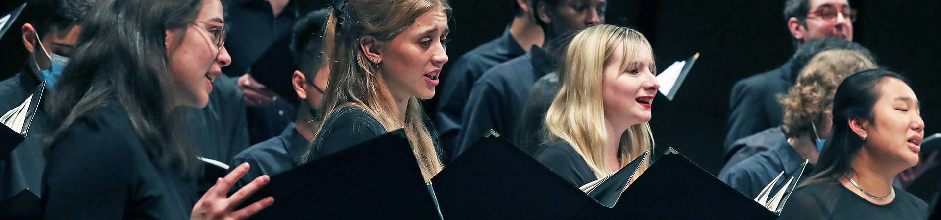 Choir members singing in performance