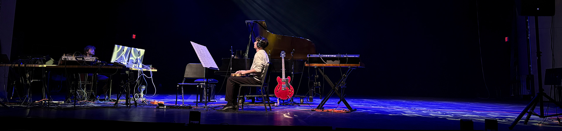 A student composer on stage practising before a concert