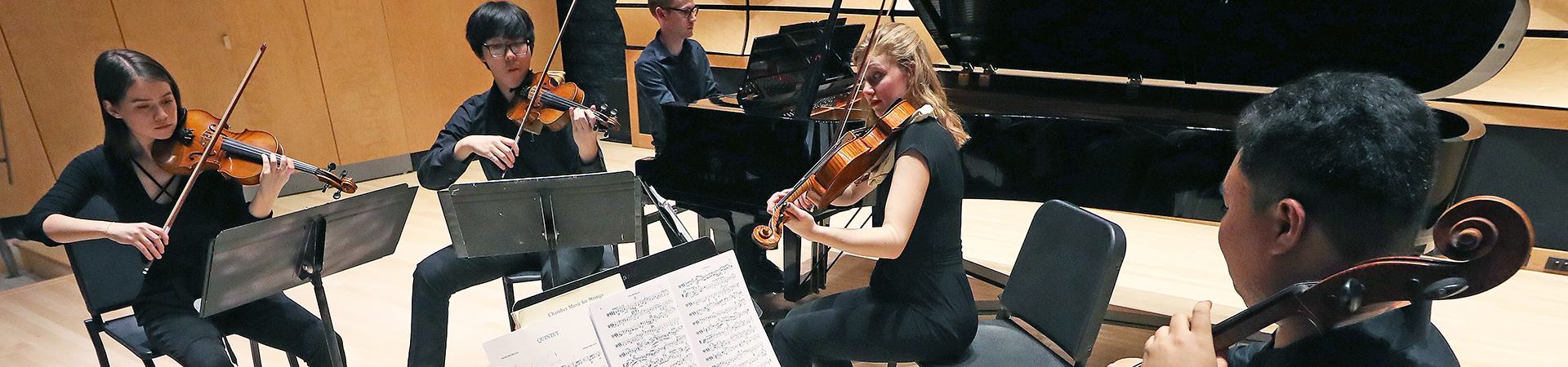 Piano Quintet chamber group performs on stage in von Kuster Hall