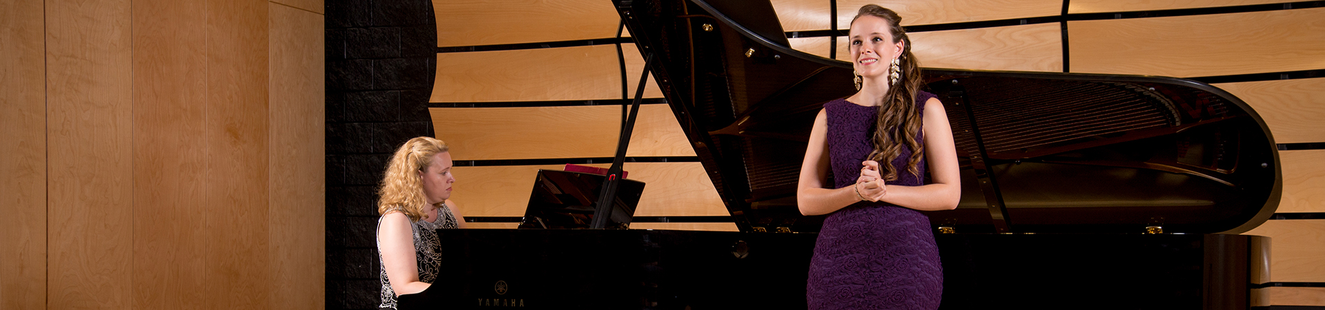 Singer with piano accompanist on stage in von Kuster Hall