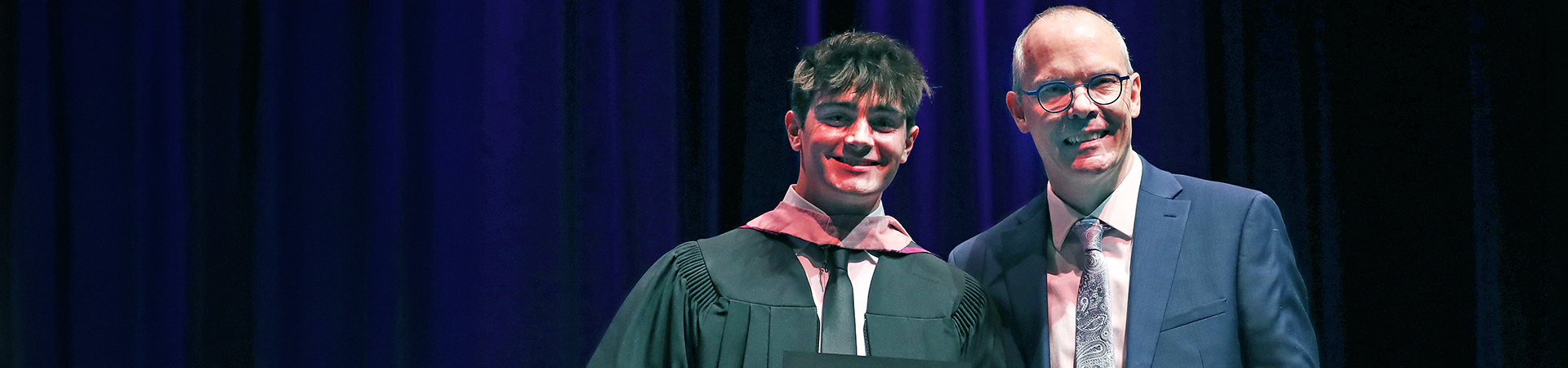 Award recipient receiving an award from a music faculty member