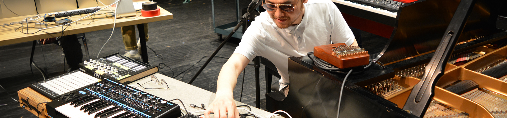 Student composer on stage in rehearsal