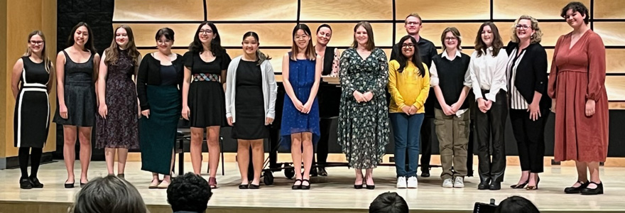 Participant group photo: Kiki B., Erika G., Tessa H., Josie C., Arshida K., Caitlin M., Margaret N., Ellieanna Yurchuk, Manya H., Sal R., Claire M., faculty organizer Beth Horst, Clara M. taken at close of competition on October 20 in von Kuster Hall. Collaborative pianists Marianna Chibotar-Rutkevich and Connor O'Kane are pictured in the back. (Not pictured, Matthew Y., Shanthi V.) Photo credit: C. Mann