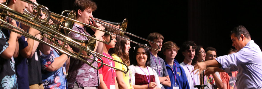Photo: Denis Jiron (right), host of the 2025 International Trombone Festival, gathers musicians for a resounding performance of dozens of trombones playing simultaneously. (Western News/Colleen MacDonald)