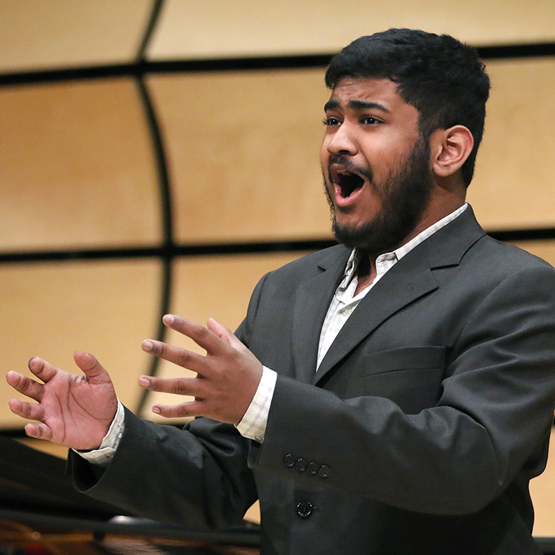Participant in high school vocal competition while singing
