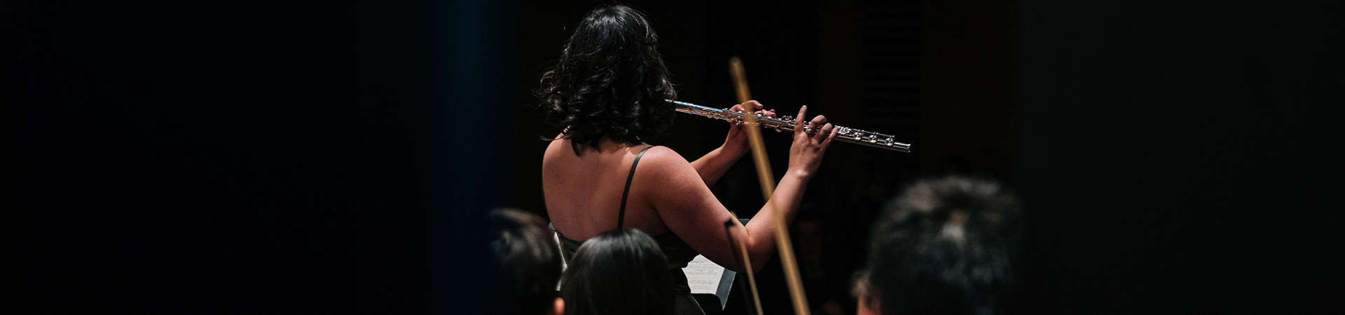Flute player performing with the symphony orchestra