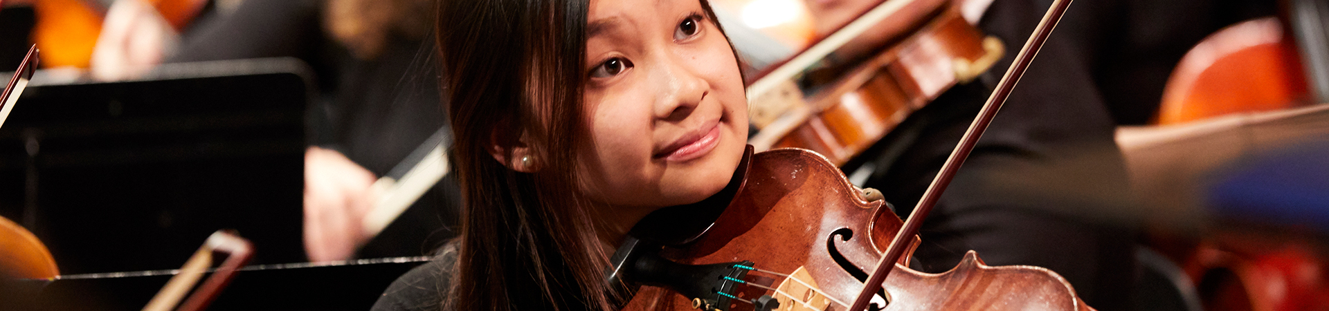 A viola player on stage performing